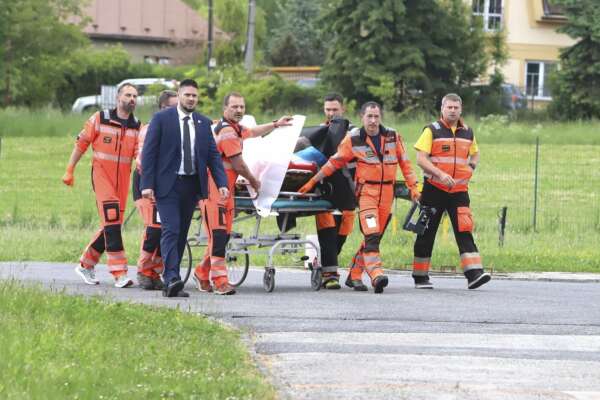 Rescue workers wheel Slovak Prime Minister Robert Fico, who was shot and injured, to a hospital in the town of Banska Bystrica, central Slovakia, Wednesday, May 15, 2024. (Jan Kroslak/TASR via AP)
