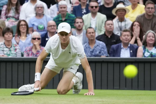 Jannik Sinner of Italy falls during his quarterfinal match against Daniil Medvedev of Russia at the Wimbledon tennis championships in London, Tuesday, July 9, 2024. (AP Photo/Alberto Pezzali)