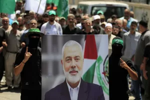 Hamas members hold a poster of Hamas political chief Ismail Haniyeh during a protest to condemn his killing, at al-Bass Palestinian refugee camp, in the southern port city of Tyre, Lebanon, Wednesday, July 31, 2024. Haniyeh, Hamas’ political chief in exile who landed on Israel’s hit list after the militant group staged its surprise Oct. 7 attacks, was killed in an airstrike in the Iranian capital early Wednesday. (AP Photo/Mohammed Zaatari) Hamas members hold a poster of Hamas political chief Ismail Haniyeh during a protest to condemn his killing, at al-Bass Palestinian refugee camp, in the southern port city of Tyre, Lebanon, Wednesday, July 31, 2024. Haniyeh, Hamas’ political chief in exile who landed on Israel’s hit list after the militant group staged its surprise Oct. 7 attacks, was killed in an airstrike in the Iranian capital early Wednesday. (AP Photo/Mohammed Zaatari)