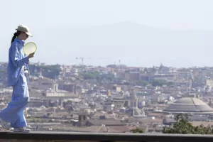 A woman walks on the balcony overlooking row city skyline on the Pincio hill as temperatures are reaching up to 39 degrees Celsius (102.20 Fahrenheit) in Rome, Saturday, Aug. 10, 2024. (AP Photo/Gregorio Borgia) 



Associated Press / LaPresse
Only italy and Spain