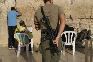 A member of the Israeli security forces prays at the Western Wall in Jerusalem’s Old City, Tuesday, Dec. 3, 2024. (AP Photo/Matias Delacroix)