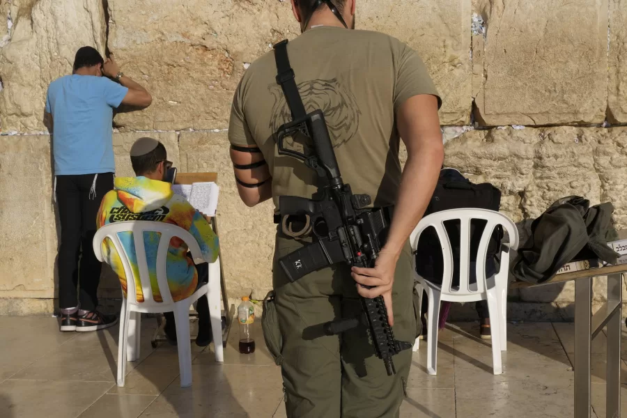 A member of the Israeli security forces prays at the Western Wall in Jerusalem’s Old City, Tuesday, Dec. 3, 2024. (AP Photo/Matias Delacroix)