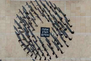 Activists takes part in a performance in Tel Aviv, Israel, calling to stop the war and for the release the hostages being held in Gaza, Friday, Jan. 10, 2025. (AP Photo/Ohad Zwigenberg)