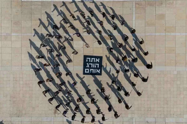 Activists takes part in a performance in Tel Aviv, Israel, calling to stop the war and for the release the hostages being held in Gaza, Friday, Jan. 10, 2025. (AP Photo/Ohad Zwigenberg)