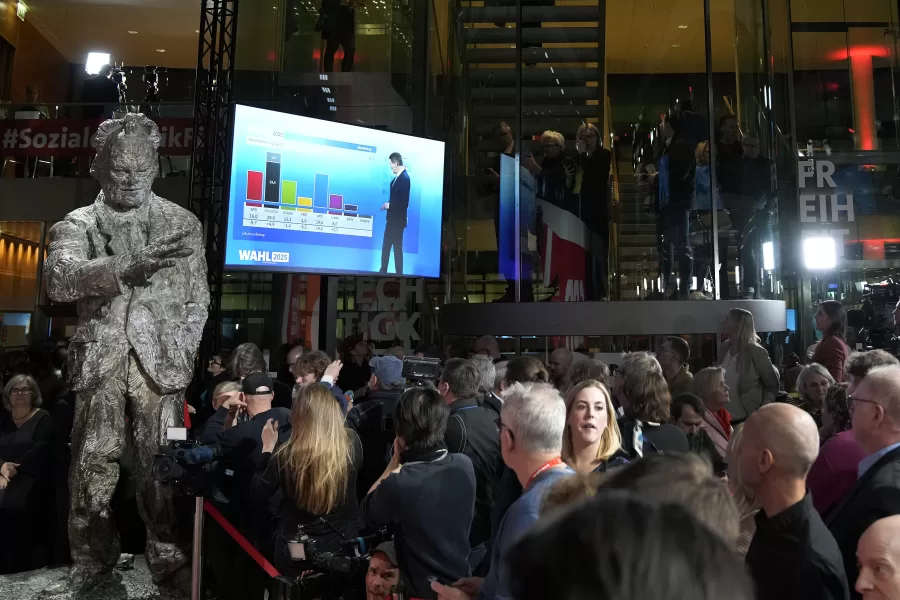 People react after first projections are announced during the election party at the Social Democratic Party (SPD) headquarters in Berlin, Germany, Sunday, March 23, 2025. (AP Photo/Ebrahim Noroozi)