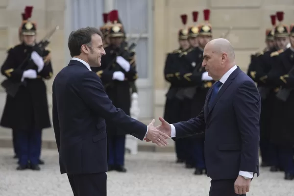 France’s President Emmanuel Macron, left, welcomes Romania’s Interim President Ilie Boloja, before a meeting on European security, Wednesday, Feb. 19, 2025, at the Elysee Palace in Paris. (AP Photo/Thibault Camus)