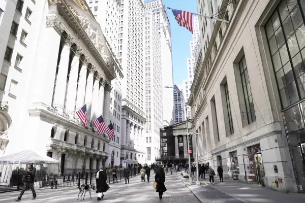 The New York Stock Exchange, left, is seen in New York, Tuesday, April 8, 2025. (AP Photo/Seth Wenig)