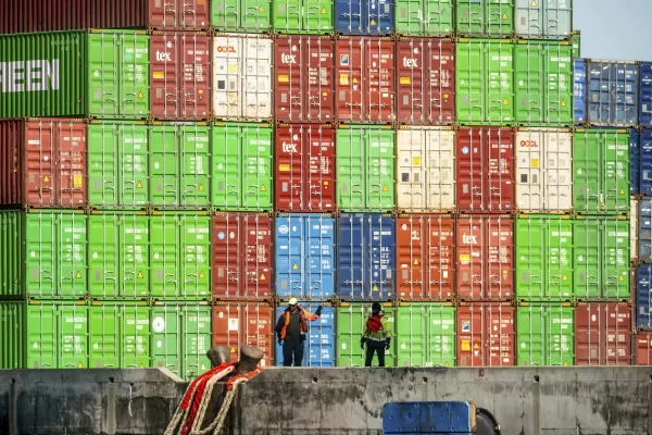 Dockworkers secure lines from a container ship at the Port of Oakland on Friday, April 4, 2025, in Oakland, Calif. (AP Photo/Noah Berger)