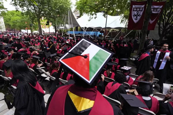 A student displays the Palestinian flag on his mortar board as graduates take their seats in Harvard Yard during commencement at Harvard University, Thursday, May 23, 2024, in Cambridge, Mass. (AP Photo/Charles Krupa) A student displays the Palestinian flag on his mortar board as graduates take their seats in Harvard Yard during commencement at Harvard University, Thursday, May 23, 2024, in Cambridge, Mass. (AP Photo/Charles Krupa)