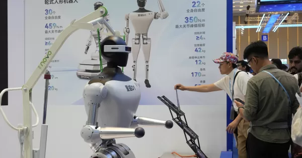 Visitors look at robots at the 137th Canton Fair in Guangzhou in southern China’s Guangdong province on Wednesday, April 16, 2025. (AP Photo/Ng Han Guan)