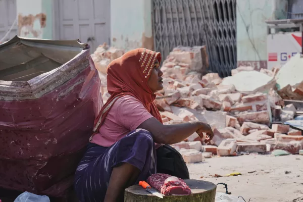 A beef vendor waits for customers at a local bazaar near damaged building by the earthquake in Naypyitaw, Myanmar, Tuesday, April 1, 2025. (AP Photo)