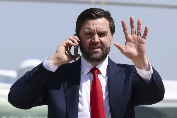 Vice President JD Vance talks on the phone before boarding Air Force Two as he departs for South Carolina to visit a steel factory, at Joint Base Andrews, Md., Thursday, May 1, 2025. (Kevin Lamarque/Pool Photo via AP)