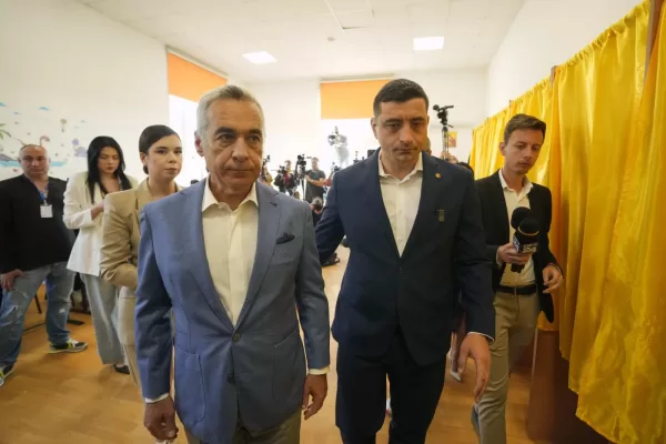 Calin Georgescu, winner of the first round of last year’s annulled election, left, and Presidential candidate George Simion exit after casting their votes in the first round of the presidential election redo in Bucharest, Romania, Sunday, May 4, 2025. (AP Photo/Vadim Ghirda)