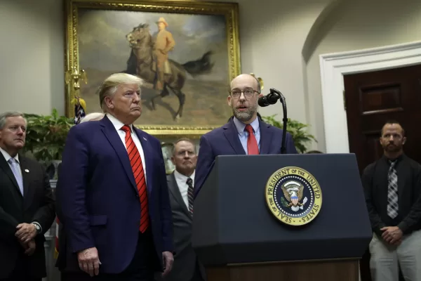 FILE – President Donald Trump listens as acting director of the Office of Management and Budget Russ Vought speaks during an event on “transparency in Federal guidance and enforcement” in the Roosevelt Room of the White House, Oct. 9, 2019, in Washington. (AP Photo/Evan Vucci, File)