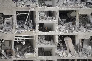 Israel’s home front command officers survey the site of a direct missile strike launched from Iran in Tel Aviv, Israel, Sunday, June 22, 2025. (AP Photo/Oded Balilty)