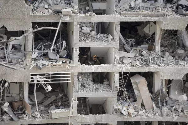 Israel’s home front command officers survey the site of a direct missile strike launched from Iran in Tel Aviv, Israel, Sunday, June 22, 2025. (AP Photo/Oded Balilty)