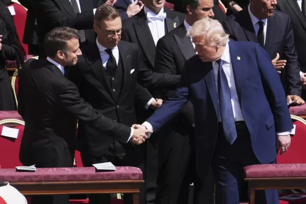 President Donald Trump, right, shakes hands with French President Emmanuel Macron, left, as Finland’s President Alexander Stubb, looks on, as they attend the funeral of Pope Francis in St. Peter’s Square at the Vatican, Saturday, April 26, 2025. (AP Photo/Evan Vucci) President Donald Trump, right, shakes hands with French President Emmanuel Macron, left, as Finland’s President Alexander Stubb, looks on, as they attend the funeral of Pope Francis in St. Peter’s Square at the Vatican, Saturday, April 26, 2025. (AP Photo/Evan Vucci)