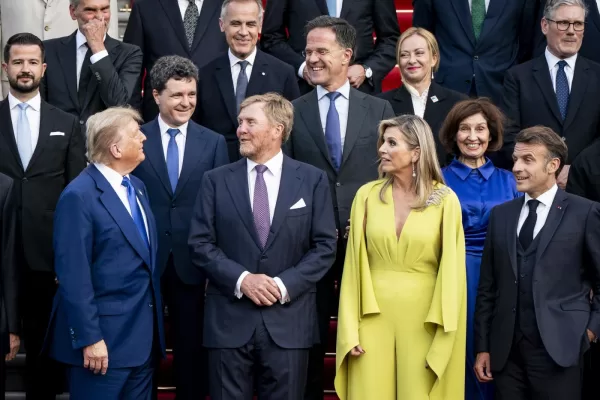 US President Donald Trump, left, talks with secretary general of NATO Mark Rutte, center, during a family photo at the 2025 NATO summit in The Hague, on Tuesday, June 24, 2025. (Haiyun Jiang/Pool Photo via AP)