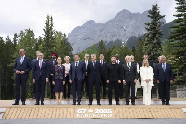 Canada’s Prime Minister Mark Carney, center, smiles as he stands with G7 leaders and outreach countries, international organizations and invited guests at the G7 Summit, Tuesday, June 17, 2025, in Kananaskis, Alberta. (Adrian Wyld/The Canadian Press via AP)