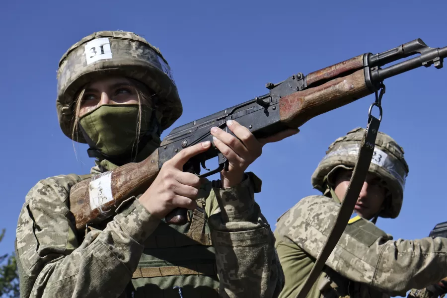 In this photo provided by Ukraine’s 65th Mechanized Brigade press service, recruits practice military skills on a training ground in a sunflower field in the Zaporizhzhia region, Ukraine, Monday, Aug. 25, 2025, (Andriy Andriyenko/Ukraine’s 65th Mechanized Brigade via AP)