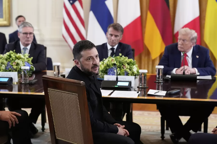 Ukraine’s President Volodymyr Zelenskyy speaks as British Prime Minister Keir Starmer, seated from background left, France’s President Emmanuel Macron and President Donald Trump listen during a meeting in the East Room of the White House, Monday, Aug. 18, 2025, in Washington. (AP Photo/Alex Brandon)