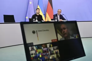 Ukrainian President Volodymyr Zelenskyy, left, and German Chancellor Friedrich Merz attend a video meeting of European leaders with US President Donald Trump on the Ukraine war in Berlin, Germany, Wednesday, Aug. 13, 2025, ahead of the summit between the US and Russian leaders. (John MacDougall/Pool Photo via AP)
