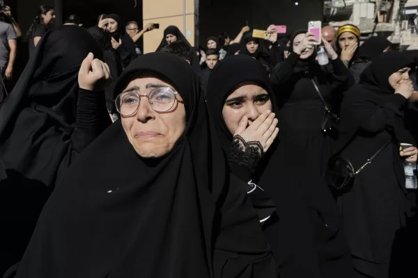 Mourners react during the funeral procession of Abu Ali Khalil, the bodyguard and head of security for late Hezbollah leader Sayyed Hassan Nasrallah, and his son Mahdi, who were killed in an Israeli airstrike in Iran on June 21, in Dahiyeh, a southern suburb of Beirut, Lebanon, Thursday, July 3, 2025. (AP Photo/Bilal Hussein)
