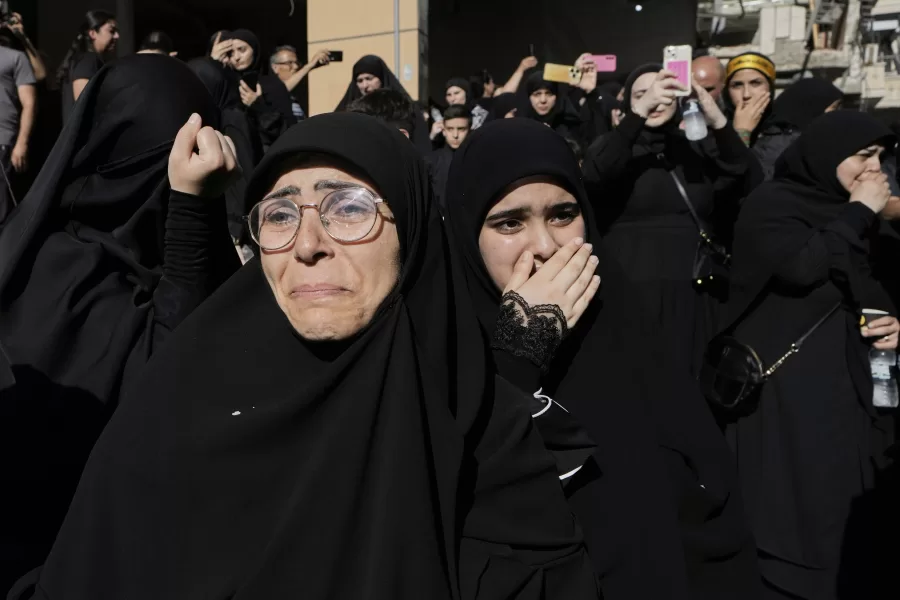 Mourners react during the funeral procession of Abu Ali Khalil, the bodyguard and head of security for late Hezbollah leader Sayyed Hassan Nasrallah, and his son Mahdi, who were killed in an Israeli airstrike in Iran on June 21, in Dahiyeh, a southern suburb of Beirut, Lebanon, Thursday, July 3, 2025. (AP Photo/Bilal Hussein)