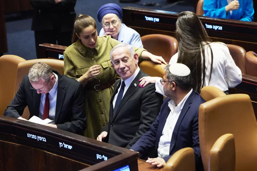 Israel’s Prime Minister Benjamin Netanyahu surrounded by ministers from the government attends a session of the Knesset, Israel’s parliament, in Jerusalem, Monday July 14, 2025. (AP Photo/Ohad Zwigenberg)