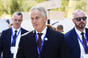 Britain’s former Prime Minister Tony Blair walks through the COP28 U.N. Climate Summit, Sunday, Dec. 3, 2023, in Dubai, United Arab Emirates. (AP Photo/Rafiq Maqbool)