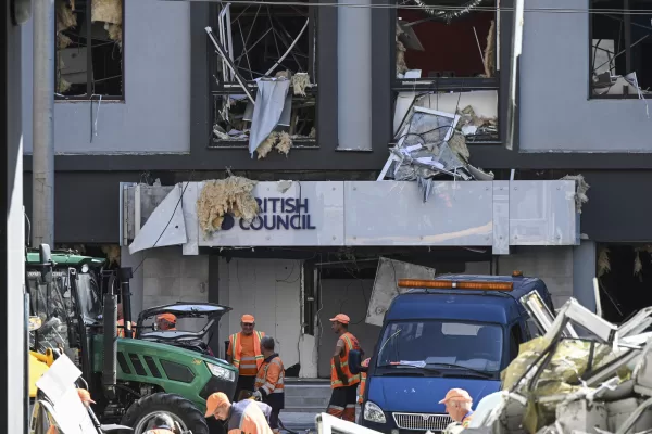 Municipal workers clear the rubble at the site of a building housing the British Council after it was hit during Russian missile and drone attacks in central Kyiv, Ukraine, Thursday, Aug. 28, 2025. (AP Photo/Danylo Antoniuk)