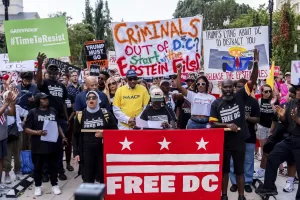 Protesters demonstrate against President Donald Trump’s planned use of federal law enforcement and National Guard troops in Washington, during a rally in front of the White House, Monday, Aug. 11, 2025, in Washington. (AP Photo/Julia Demaree Nikhinson)