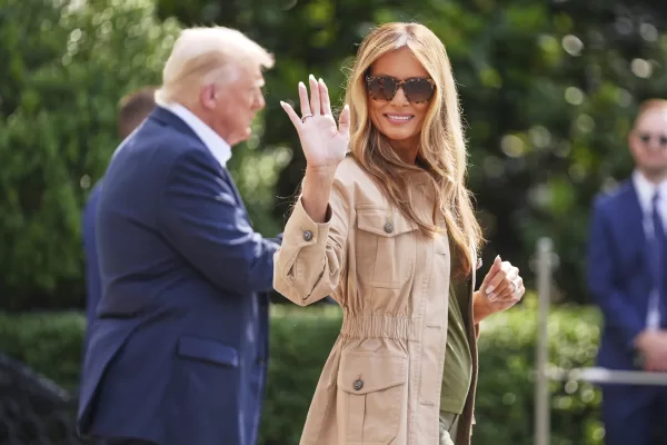 First lady Melania Trump waves as she and President Donald Trump depart the White House, Friday, July 11, 2025, in Washington. (AP Photo/Evan Vucci)