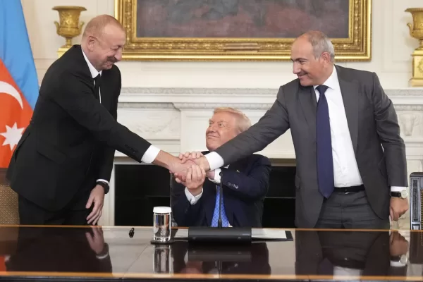 President Donald Trump, center, shakes hands with Armenian Prime Minister Nikol Pashinyan, right, and Azerbaijan President Ilham Aliyev during a trilateral signing ceremony in the State Dining Room of the White House, Friday, Aug. 8, 2025, in Washington. (AP Photo/Mark Schiefelbein)