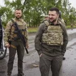 In this photo provided by the Ukrainian Presidential Press Office on Sunday, May 29, 2022, Ukrainian President Volodymyr Zelenskyy reacts as he visits the war-hit Kharkiv region. Volodymyr Zelenskyy described the situation in the east as "indescribably difficult." The "Russian army is trying to squeeze at least some result" by concentrating its attacks there, he said in a Saturday night video address. (Ukrainian Presidential Press Office via AP)