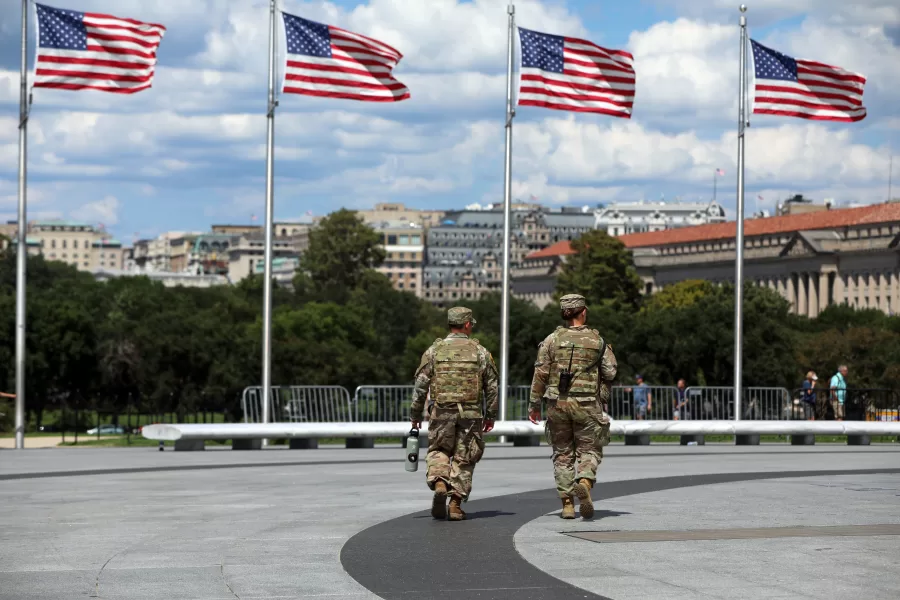 National Guardsmen patrol at the base of the Washington Monument, Monday, Aug. 25, 2025, in Washington. (AP Photo/Rahmat Gul)