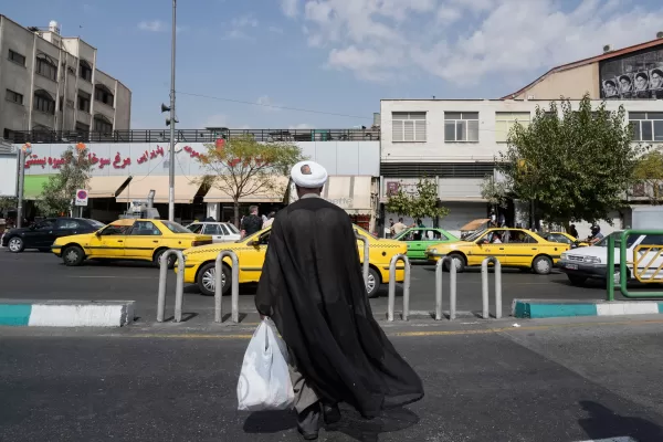 A cleric crosses the Enqelab-e-Eslami (Islamic Revolution) street, in Tehran, Iran, Saturday, Sept. 27, 2025. (AP Photo/Vahid Salemi)