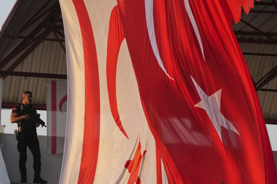 A security officer stands guard as the Turkish President Recep Tayyip Erdogan, attend the military parade marking the 51st anniversary of the 1974 Turkish invasion in the Turkish occupied area, in the divided capital of Nicosia, Cyprus, Sunday, July 20, 2025. (AP Photo/Petros Karadjias)