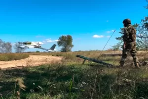 In this photo taken from video distributed by Russian Defense Ministry Press Service on Wednesday, Sept. 24, 2025, A Russian soldier launches a drone for an action in an undisclosed location in Ukraine. (Russian Defense Ministry Press Service via AP)