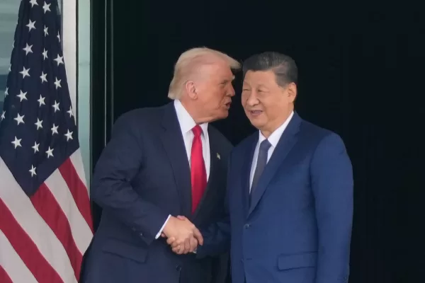 President Donald Trump, left, and Chinese President Xi Jinping, right, shake hands after their U.S.-Chin summit meeting at Gimhae International Airport Jinping in Busan, South Korea, Thursday, Oct. 30, 2025. (AP Photo/Mark Schiefelbein)