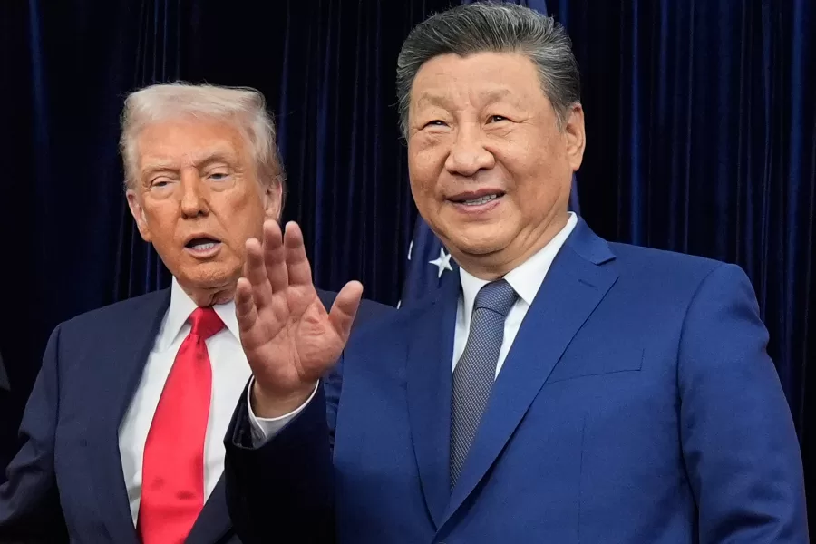 Chinese President Xi Jinping, right, waves, with President Donald Trump, ahead of their summit talk at Gimhae International Airport in Busan, South Korea, Thursday, Oct. 30, 2025. (AP Photo/Mark Schiefelbein)