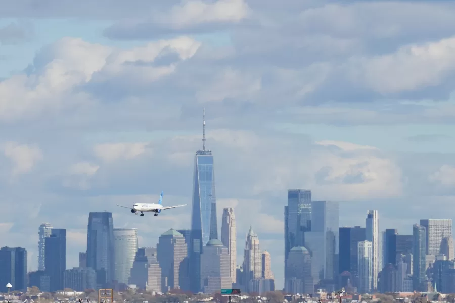 The New York City skyline is seen behind a plane approaching Newark International Airport in Newark, N.J., Thursday, Nov. 6, 2025. (AP Photo/Seth Wenig)