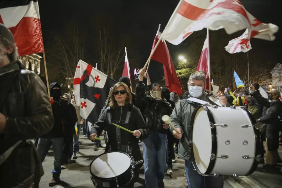 Demonstrators with Georgian national flags rally to call for the release of political prisoners and demand new elections in the center of Tbilisi, Georgia, Monday, March 31, 2025. (AP Photo/Zurab Tsertsvadze)