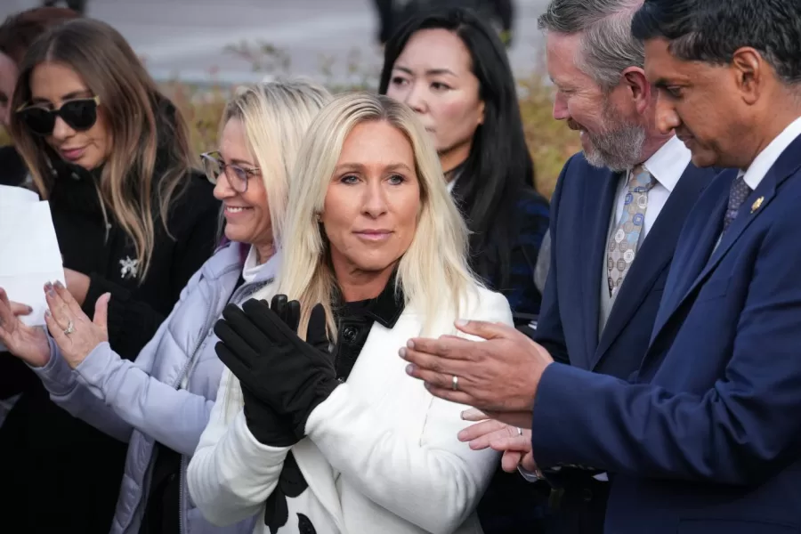 Rep. Marjorie Taylor-Greene, R-Ga., center, with Rep. Thomas Massie, R-Ky., second from right, and Rep. Ro Khanna, D-Calif., far right, applauds during a news conference as the House prepares to vote on the Epstein Files Transparency Act, at the Capitol in Washington, Tuesday, Nov. 18, 2025. (AP Photo/J. Scott Applewhite)