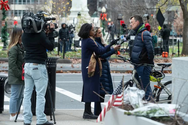Members of the news media interview a passer-by at the scene where, a day after, two National Guard soldiers were shot near the White House in Washington, Thursday, Nov. 27, 2025. (AP Photo/Cliff Owen)