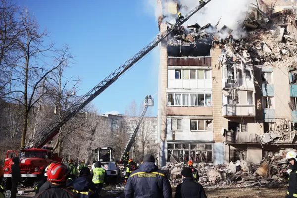 Rescue workers put out a fire of a residential building which was heavily damaged by a Russian strike on Ternopil, Ukraine, on Wednesday, Nov. 19, 2025. (AP Photo/Rostyslav Kovalchuk)