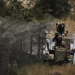 Syrian Druze protest near the Israeli-Syrian border, as seen from the town of Majdal Shams in the Israeli-controlled Golan Heights, Wednesday, July 16, 2025, amid the ongoing clashes between Syrian government forces and Druze armed groups in the southern Syrian city of Sweida. (AP Photo/Leo Correa)