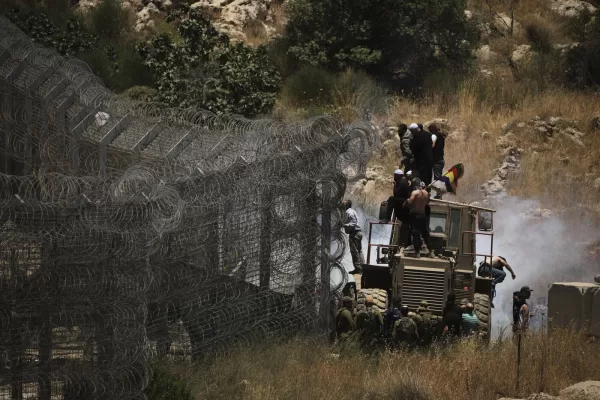 Syrian Druze protest near the Israeli-Syrian border, as seen from the town of Majdal Shams in the Israeli-controlled Golan Heights, Wednesday, July 16, 2025, amid the ongoing clashes between Syrian government forces and Druze armed groups in the southern Syrian city of Sweida. (AP Photo/Leo Correa)