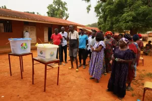 People queue at a polling station to cast their ballots during the Presidential and legislative elections in Bissau, Guinea-Bissau, Sunday, Nov. 23, 2025. (AP Photo/Darcicio Barbosa)