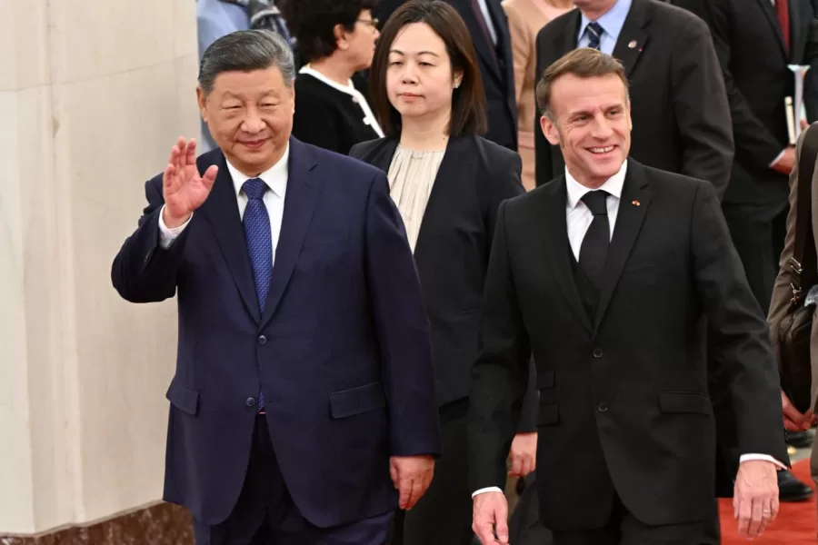 France’s President Emmanuel Macron, right, and China’s President Xi Jinping, left, walk during a state visit at the Great Hall of the People in Beijing Thursday, Dec. 4, 2025. (Adek Berry/Pool Photo via AP)